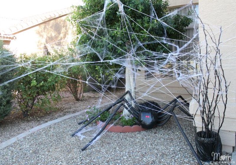 A Giant trash bag Spider with planter and spider webs 