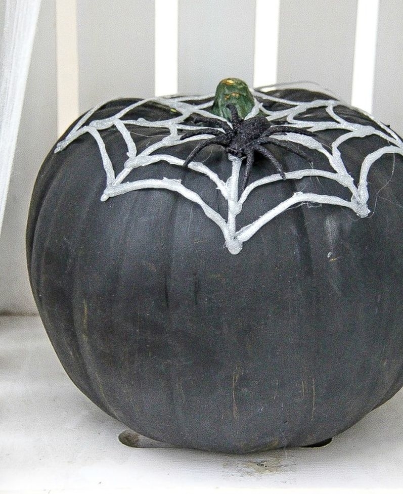 Hot Glue Spider Webs over a pumpkin  