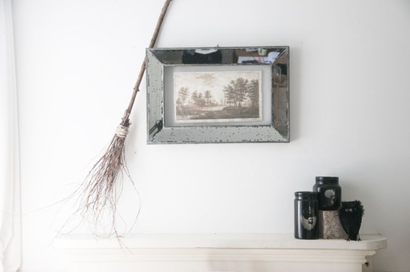 DIY witch broom behind a picture frame 