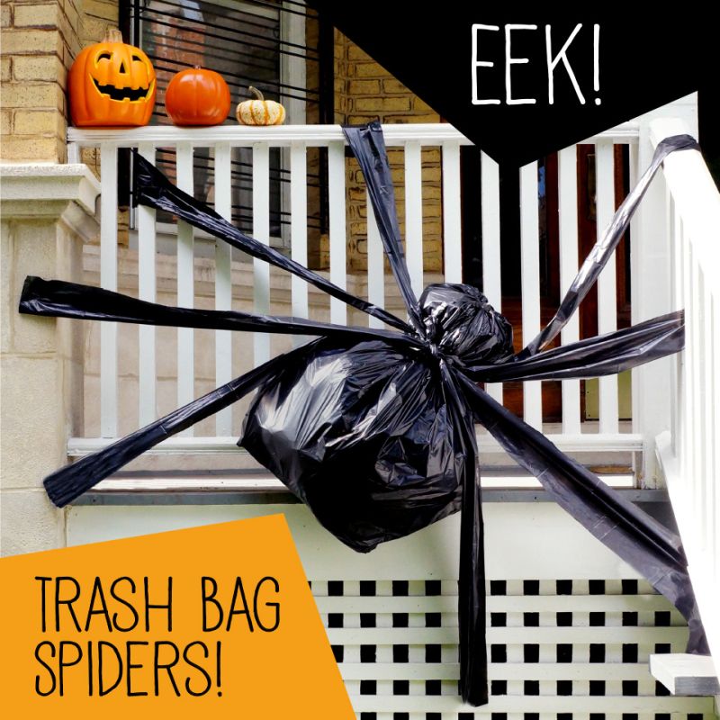 Giant trash bag spider decoration on fence  