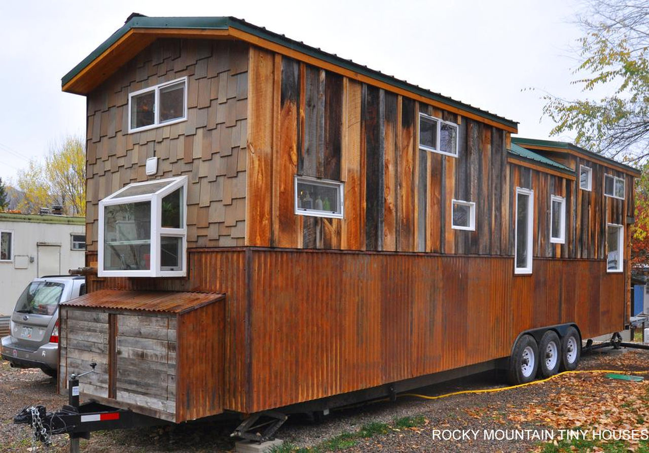 Red Mountain 34' Tiny House-wooden exterior with numerous windows
