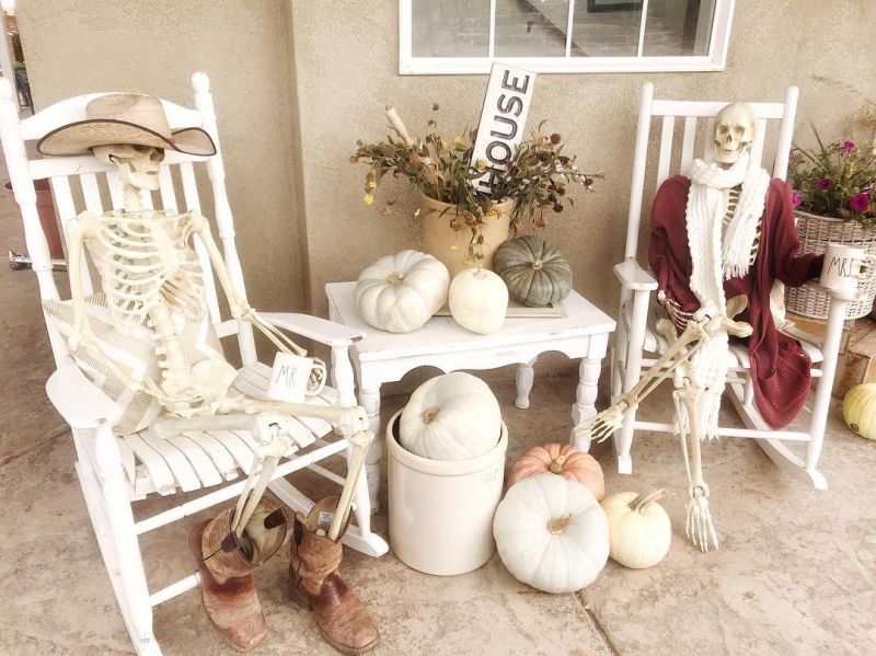Skeleton couple sitting in the front porch